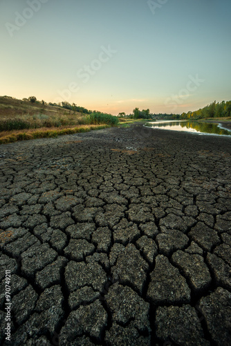 Half-dried lake b legacy of global warming summer b hot days in the summer dried up the lake. Cracked earth around the lake. The water level in the lake dropped to impressive proportions