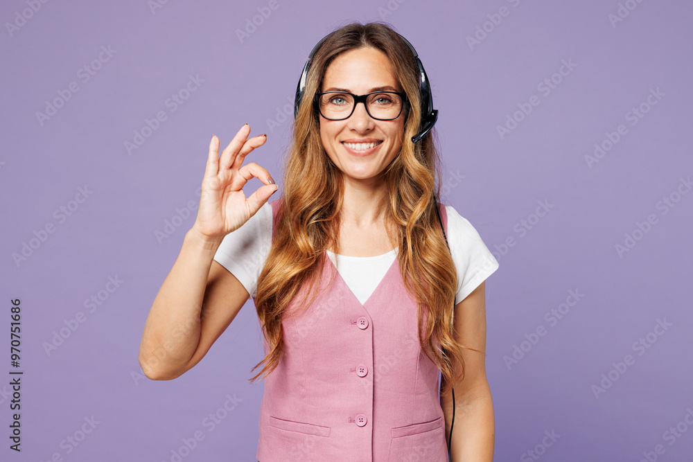 Employee happy operator business woman wear set microphone headset for helpline assistance sit work at call center office show ok okay isolated on plain pastel light purple background studio portrait. Employee happy operator business woman wear set microphone headset for helpline assistance sit work at call center office show ok okay isolated on plain pastel light purple background studio portrait.