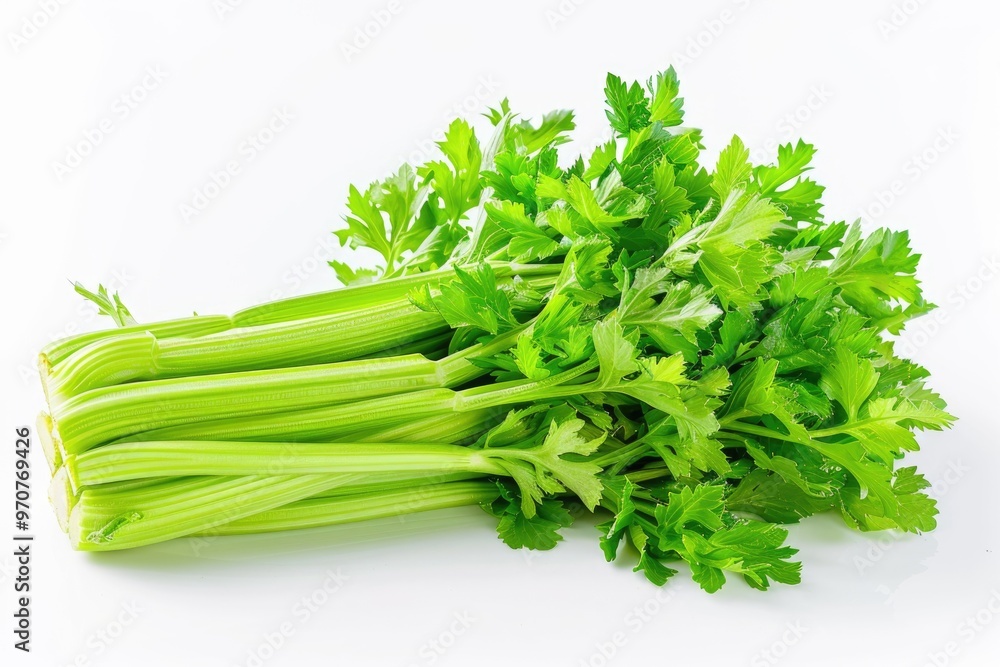 A bunch of fresh celery sitting on a white surface A bunch of fresh celery sitting on a white surface