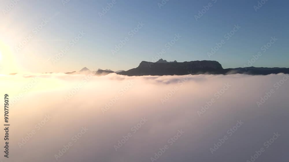 Stunning aerial view of clouds moving across the sky, with the mountain peaks of Calpe, Spain, visible in the distance, dolly to ridge Stunning aerial view of clouds moving across the sky, with the mountain peaks of Calpe, Spain, visible in the distance, dolly to ridge