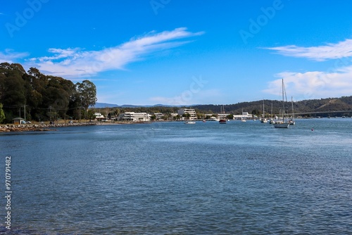 Serene coastal bay with sailboats and clear blue sky