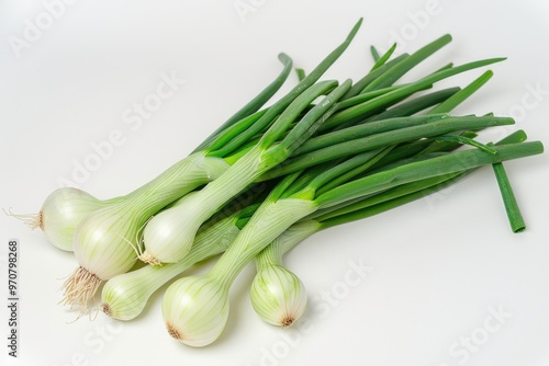 Fresh green onions arranged on a white surface