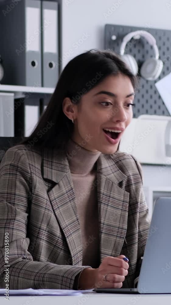 Delighted Caucasian young adult businesswoman celebrating success and applauding while working with laptop in the office. Vertical video. Delighted Caucasian young adult businesswoman celebrating success and applauding while working with laptop in the office. Vertical video.
