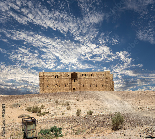 Qasr Kharana (Kharanah or Harrana)-- desert castle in eastern Jordan (100 km of Amman). Built in 8th century AD to be used as caravanserai, a resting place for traders. Against the sky with clouds photo