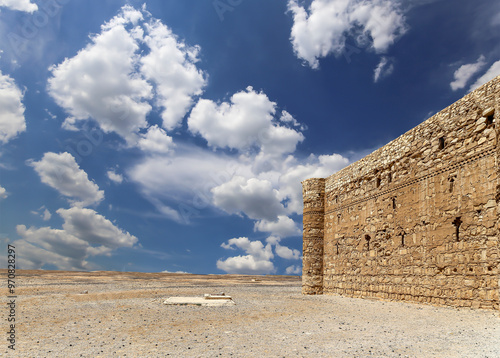 Qasr Kharana (Kharanah or Harrana)-- desert castle in eastern Jordan (100 km of Amman). Built in 8th century AD to be used as caravanserai, a resting place for traders. Against the sky with clouds photo