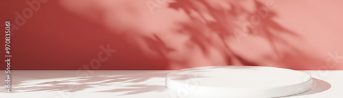 White empty round podium with soft maple leaf shadows on a warm red background. Product display background with copy space