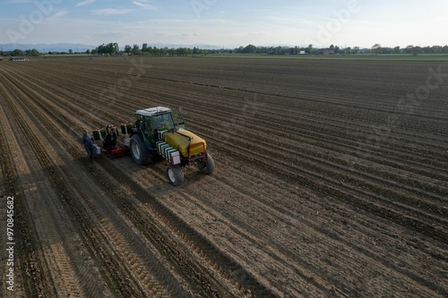 Tractor working in a vast agricultural field.