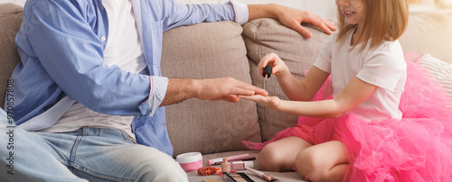 You are my best friend. Small pretty princess coloring her dad nails with polisher, man wearing crown, enjoying time with his daughter, free space