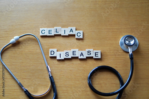 celiac disease, written in wooden letters on a wooden table with a medical stethoscope photo