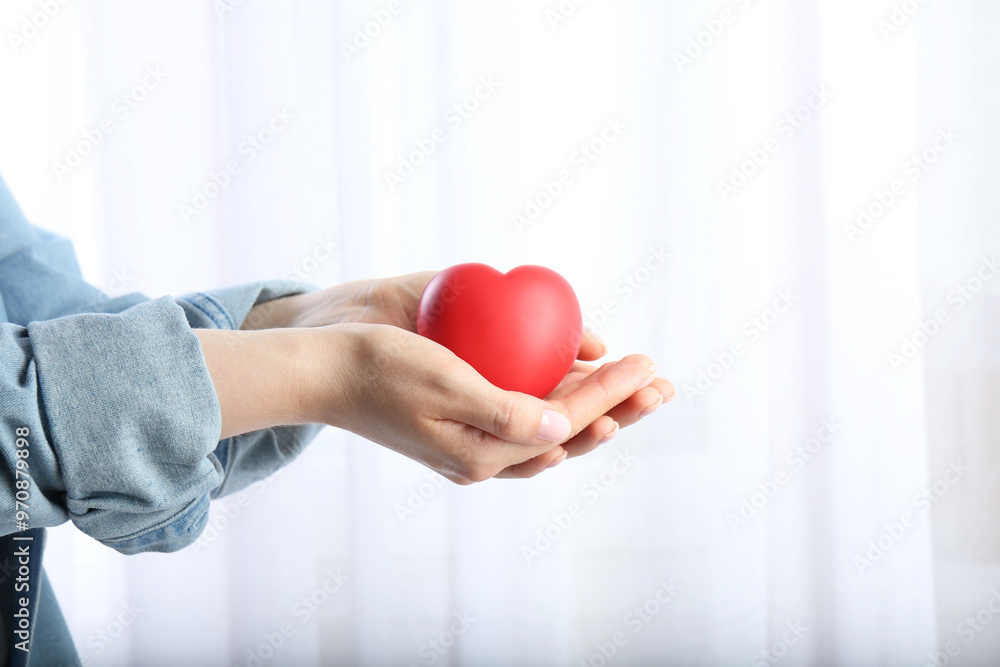 Woman holding red heart on light background, closeup Woman holding red heart on light background, closeup