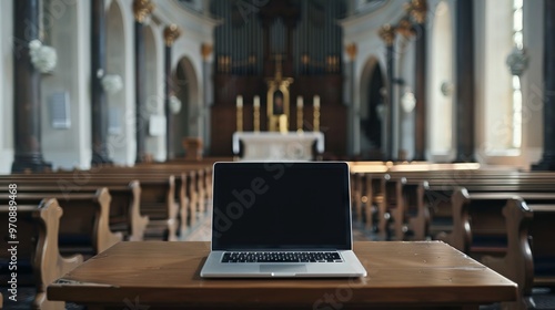 A laptop is open on a wooden table in a church