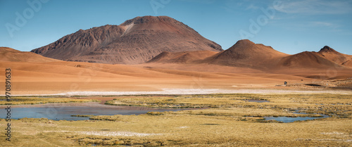 The Quebrada de Quepiaco River forms desert wetlands as it meanders through the 4000m high altiplano close to San Pedro de Atacama, Chile, displaying a distinctive ecosystem with stunning azure pools. photo