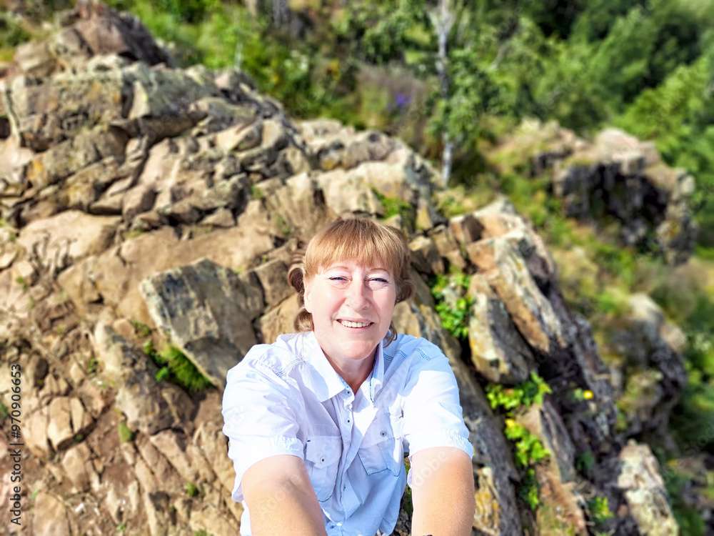 Adventures on a journey. A blogger poses, takes a selfie or podcast in the mountains with a magnificent view Adventures on a journey. A blogger poses, takes a selfie or podcast in the mountains with a magnificent view