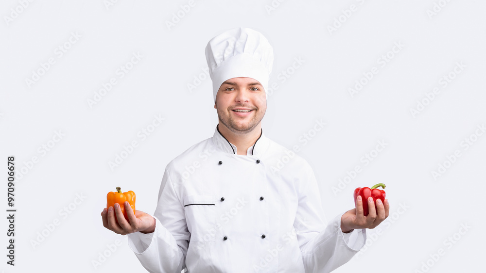 Vegetarian Recipes. Chef Guy Holding Sweet Peppers Smiling To Camera Standing On White Studio Background. Panorama Vegetarian Recipes. Chef Guy Holding Sweet Peppers Smiling To Camera Standing On White Studio Background. Panorama