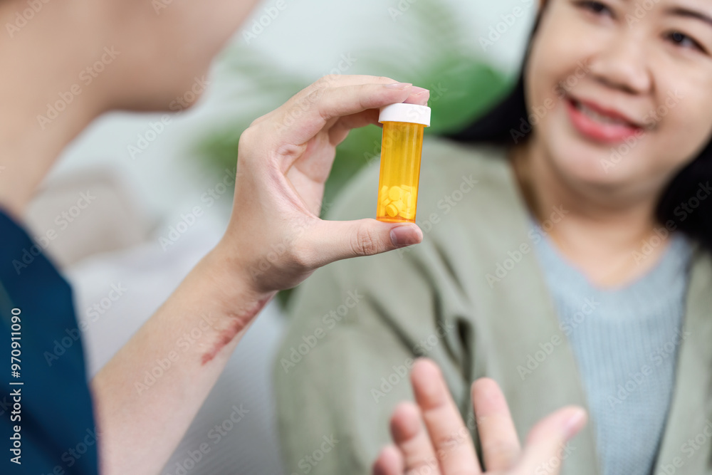 Fototapeta premium Healthcare Professional Showing Prescription Medication to Smiling Patient in a Medical Consultation