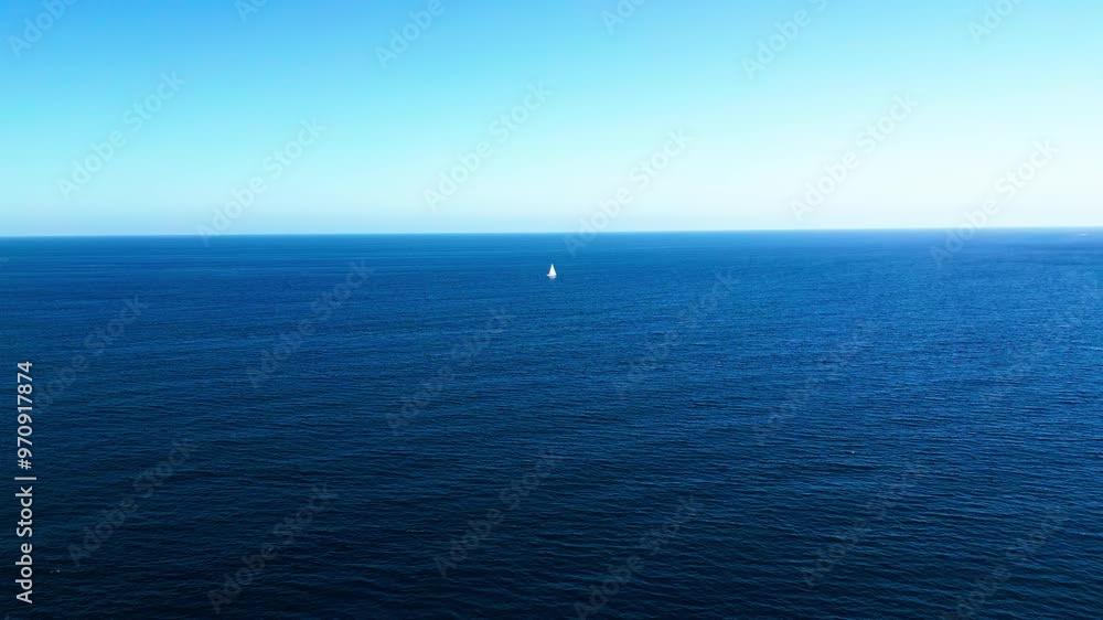 Lonely boat in the middle of the ocean during sunrise Lonely boat in the middle of the ocean during sunrise