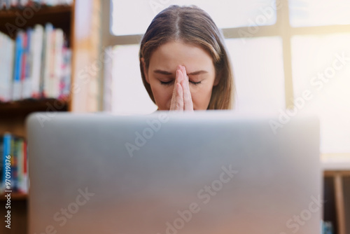 Photography Stress, library and woman with laptop, headache and fatigue and overtime on research project at university