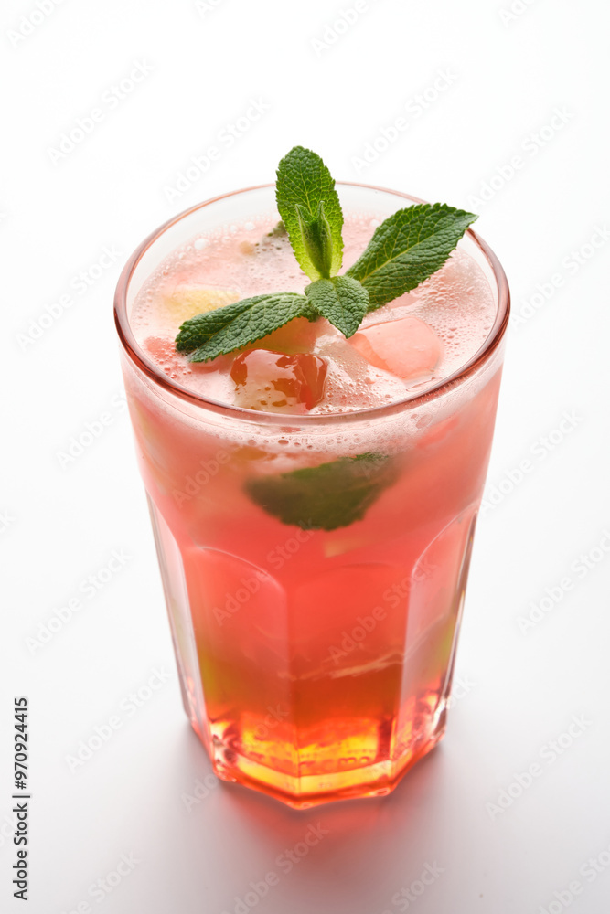 Refreshing summer cocktail with mint garnish served in a clear glass on a bright background Refreshing summer cocktail with mint garnish served in a clear glass on a bright background