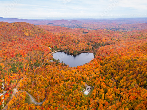 Aerial view of heart shape lake surrounded by autumn forest. Concept of earth day, love, environment, ecology. Baker Pond, Bolton-Est, Quebec, Canada.