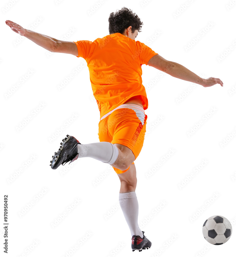 Naklejka premium Back view image of young man, soccer player wearing orange uniform, in motion with ball, training isolated on white transparent background. Concept of sport, competition, active lifestyle, game