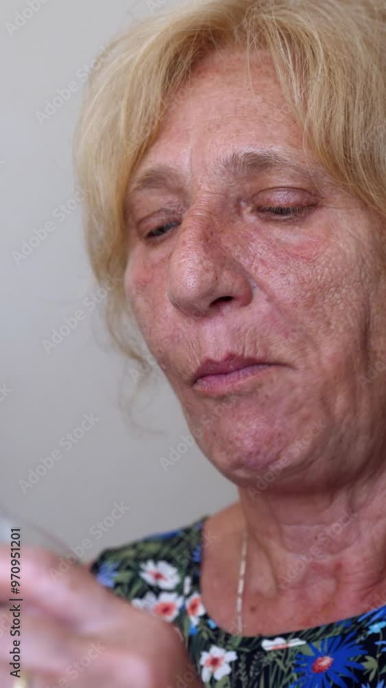 Vertical video of a woman enjoying fruit salad from a glass, savoring each bite with a spoon. She relishes the fresh and colorful fruits in a delightful moment Vertical video of a woman enjoying fruit salad from a glass, savoring each bite with a spoon. She relishes the fresh and colorful fruits in a delightful moment