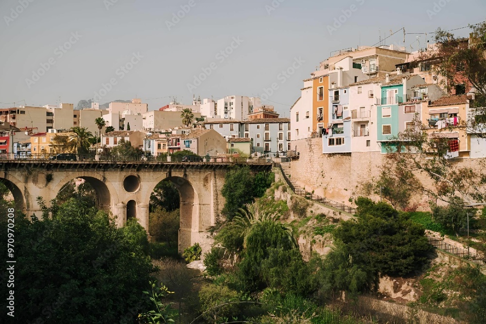 Fototapeta premium Colorful buildings and old stone bridge in a Mediterranean town