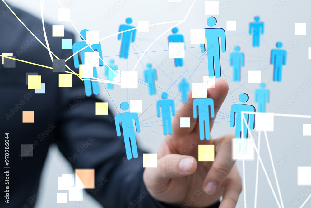 Businessman pointing to a network of people icons over a white background Businessman pointing to a network of people icons over a white background