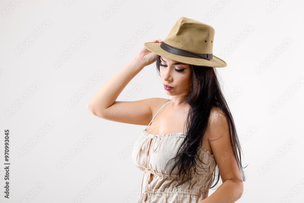 portrait of a beautiful brunette woman with a hat in different positions on a gray background portrait of a beautiful brunette woman with a hat in different positions on a gray background