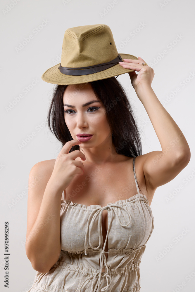portrait of a beautiful brunette woman with a hat in different positions on a gray background portrait of a beautiful brunette woman with a hat in different positions on a gray background