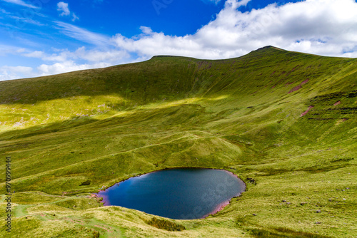 Small glacial formed lake beneath higher mountains photo