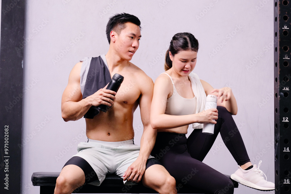 Men and women exercising with dumbbells in a fitness gym. Men and women exercising with dumbbells in a fitness gym.