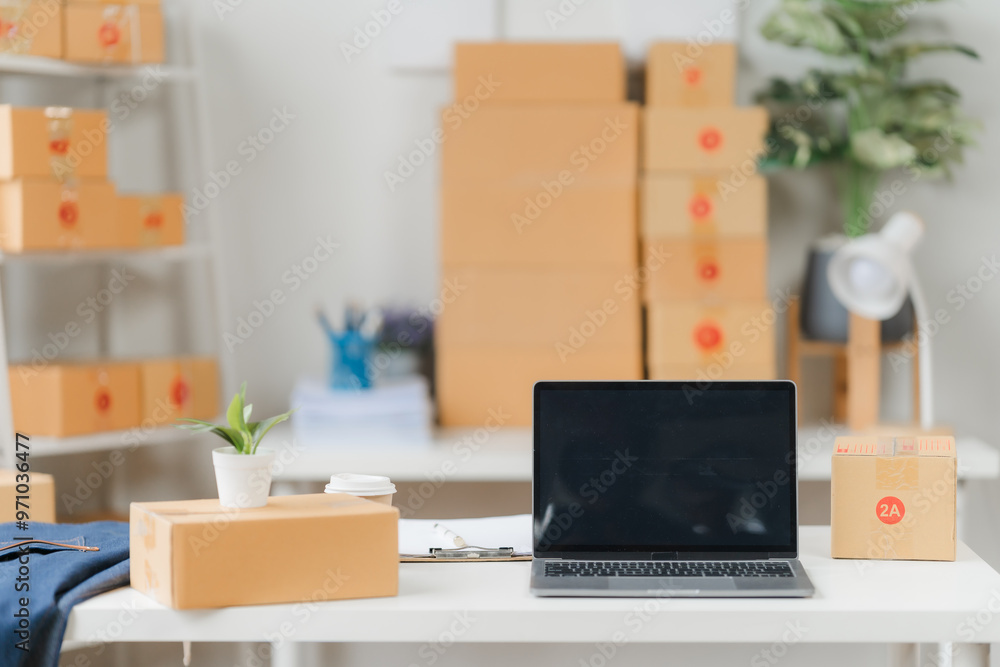 Modern E-commerce Workspace: A minimalist workspace with a laptop, stacked cardboard boxes, and a potted plant, showcasing the modern e-commerce business landscape. Modern E-commerce Workspace: A minimalist workspace with a laptop, stacked cardboard boxes, and a potted plant, showcasing the modern e-commerce business landscape.