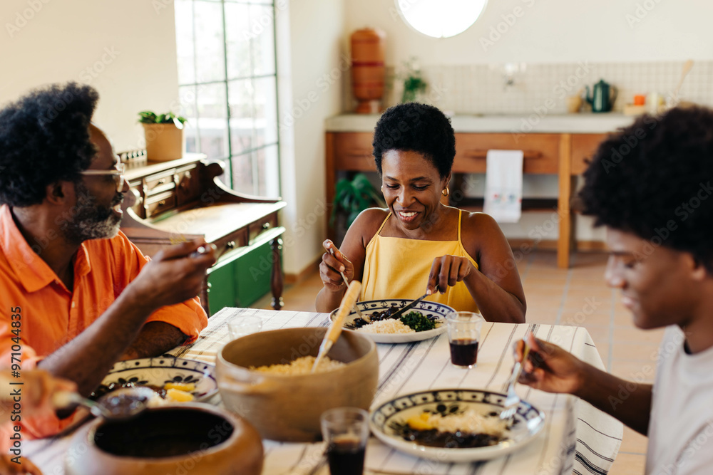 Family enjoying traditional brazilian meal together in a happy home kitchen Family enjoying traditional brazilian meal together in a happy home kitchen