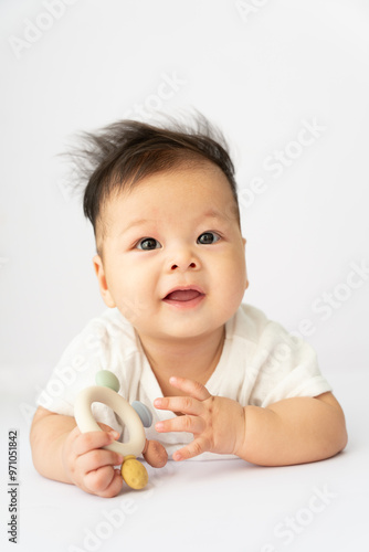 a baby playing with a toy on a white background