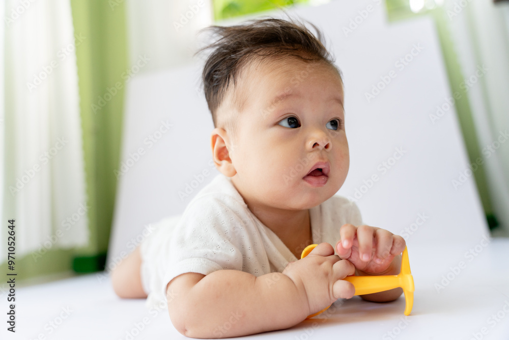 a baby sitting on a table with a tooth brush a baby sitting on a table with a tooth brush