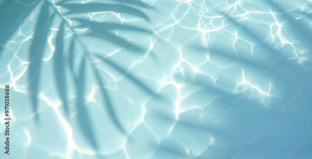 Top view of tropical leaf shadow on water surface. Shadow of palm leaves on white sand beach. Beautiful abstract background concept banner for summer vacation at the beach. Top view of tropical leaf shadow on water surface. Shadow of palm leaves on white sand beach. Beautiful abstract background concept banner for summer vacation at the beach.