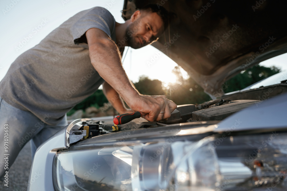 Breakdown, hood is opened, repairing. Man is with his car outdoors Breakdown, hood is opened, repairing. Man is with his car outdoors