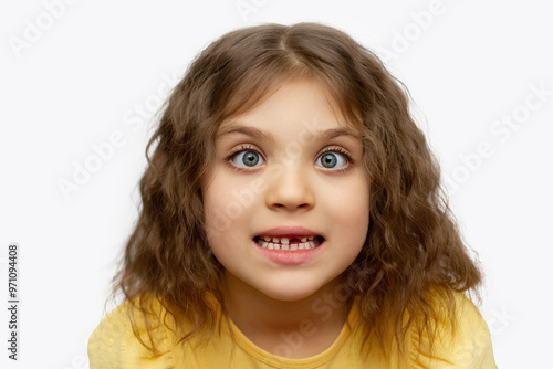 фотографія Funny girl 6 years old with goggle-eyed without one front top tooth on white bac