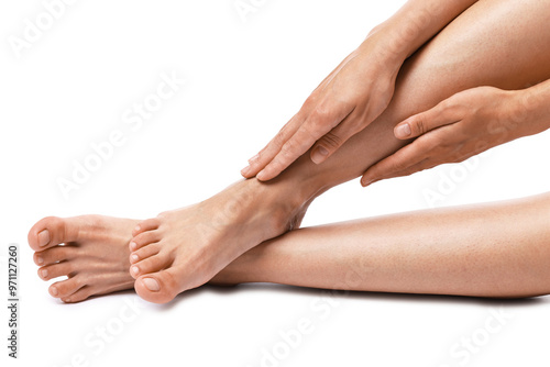 Woman touching her smooth legs on white background, closeup