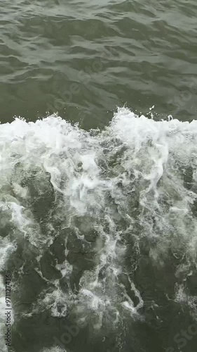 Sea foam behind the stern of the ship. Tons of water when moving turn into large waves behind the stern of a large ship. The structure of the water is manifested in unique intricate patterns. photo