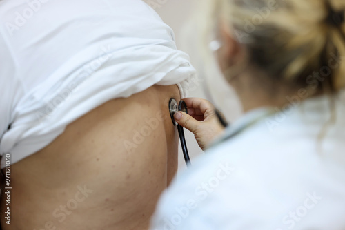 the doctor listens to the patient's lungs and heartbeat