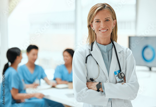 Mature woman, doctor and happy with arms crossed in boardroom as mentor or leader for training. People, meeting and smile at hospital on portrait for workshop on teamwork, collaboration and strategy