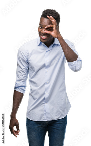 Young african american man wearing a shirt with happy face smiling doing ok sign with hand on eye looking through fingers