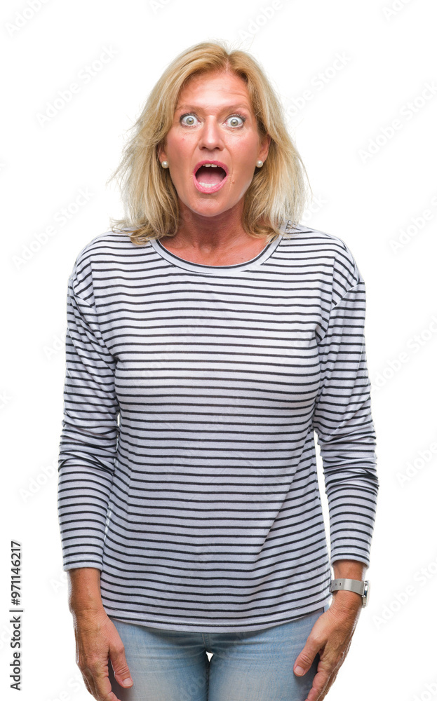 Middle age blonde woman over isolated background afraid and shocked with surprise expression, fear and excited face. Middle age blonde woman over isolated background afraid and shocked with surprise expression, fear and excited face.