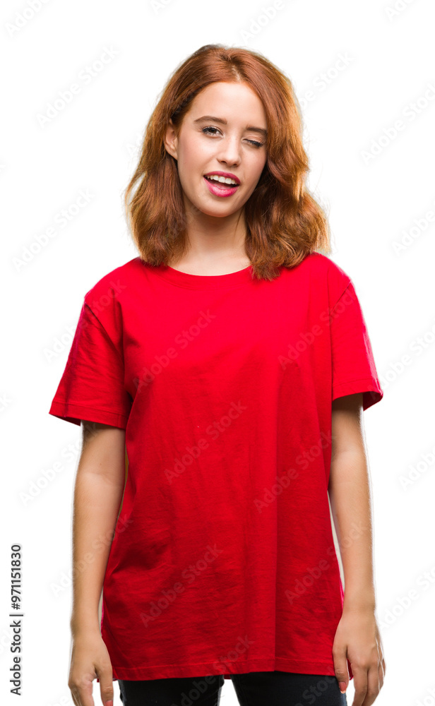 Fototapeta premium Young beautiful woman over isolated background winking looking at the camera with sexy expression, cheerful and happy face.