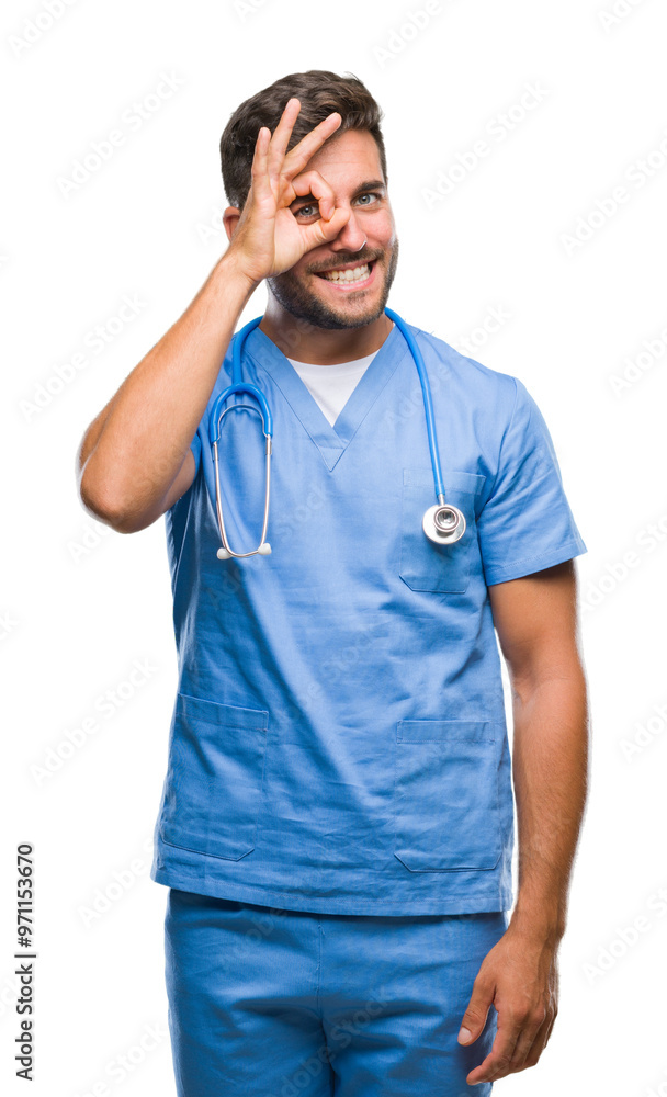 Fototapeta premium Young handsome doctor surgeon man over isolated background doing ok gesture with hand smiling, eye looking through fingers with happy face.