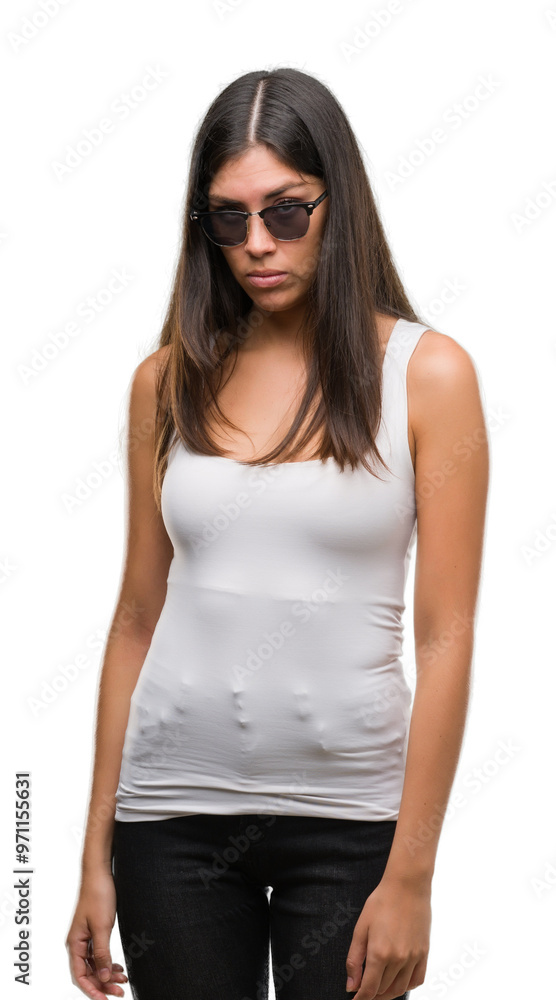 Young beautiful hispanic wearing sunglasses skeptic and nervous, frowning upset because of problem. Negative person.