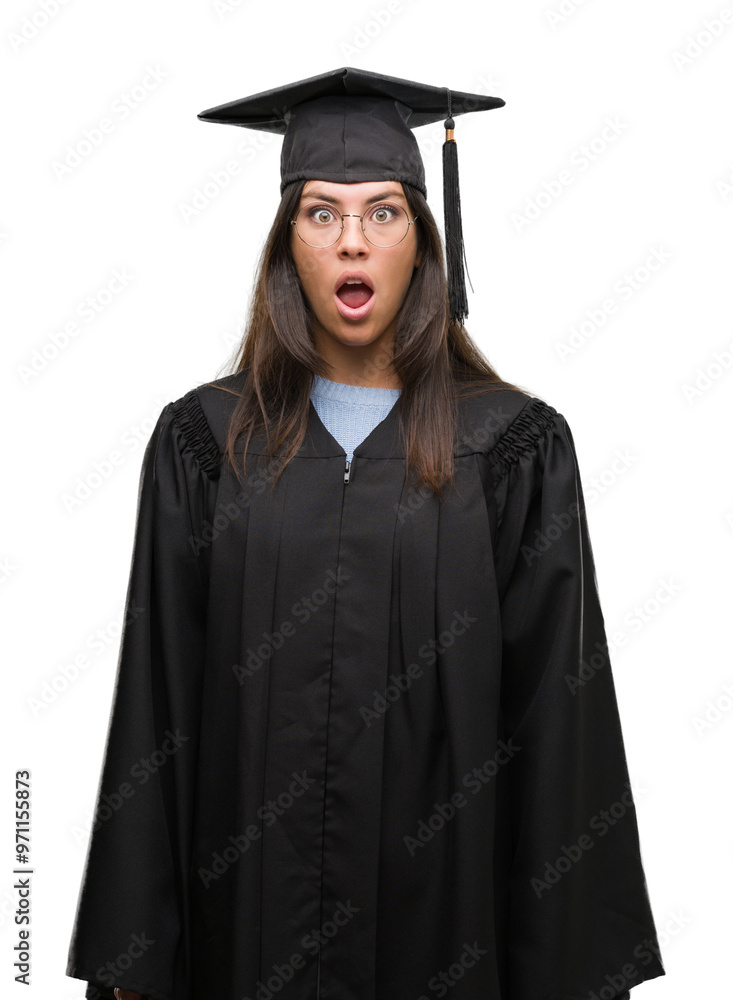 Young hispanic woman wearing graduated cap and uniform afraid and shocked with surprise expression, fear and excited face. Young hispanic woman wearing graduated cap and uniform afraid and shocked with surprise expression, fear and excited face.