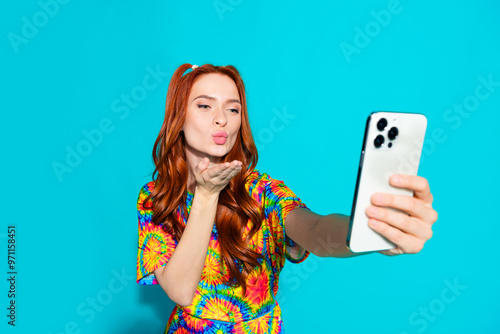 Photo portrait of lovely young lady send air kiss selfie photo dressed stylish colorful garment isolated on cyan color background photo