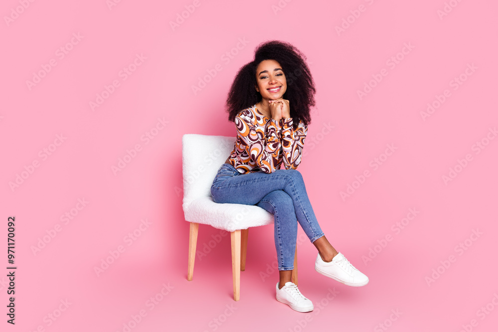 Full length photo of shiny dreamy lady dressed print shirt sitting chair empty space isolated pink color background Full length photo of shiny dreamy lady dressed print shirt sitting chair empty space isolated pink color background